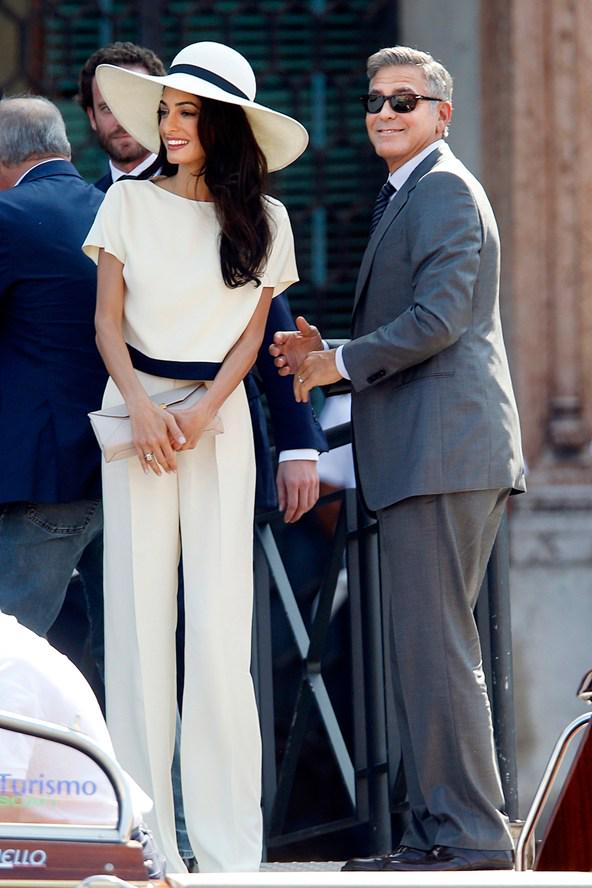 BritishVogue's tweet photo. As the Clooneys celebrate their one year anniversary, revisit Amal's wedding wardrobe - http://t.co/MjnLbjJHZs http://t.co/8ekYlSPrQY
