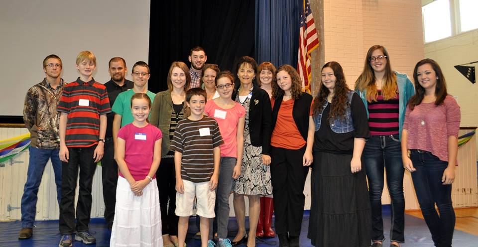 BRCSchool's tweet photo. BRCS Teacher MaryFaith Fawley, honored for 25yrs of service, with students and alumni #BRCSstrongertogether http://t.co/Da1rz35GqT