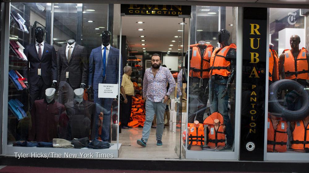 nytimes's tweet photo. Turkey's clothing stores now display life vests in the hopes of making money off migrants http://t.co/5qBJ5wDueJ http://t.co/xudw2v9xQo