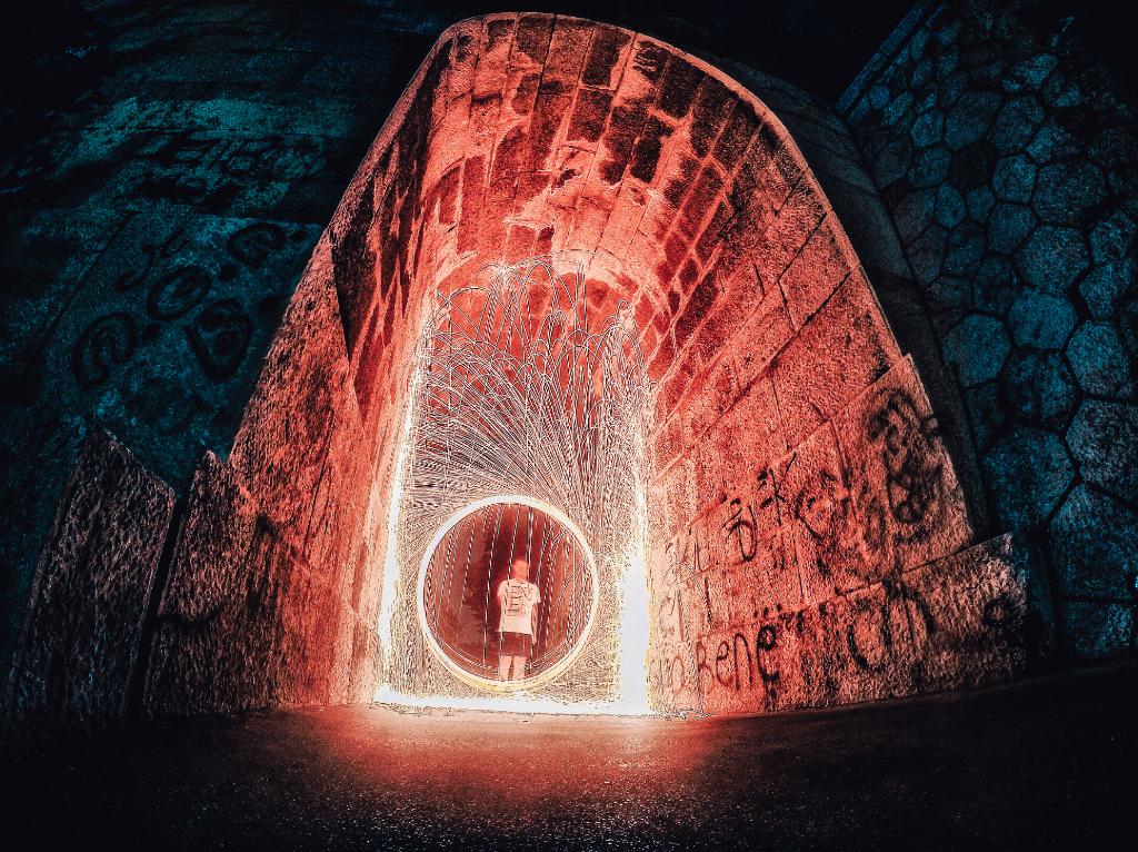 GoPro's tweet image. Photo of the Day! Enrico Andreis sets a fiery scene underneath a bridge using a #HERO4Silver set on Night Lapse.