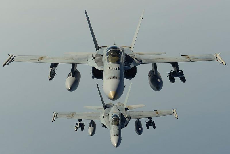 Austerican_man's tweet photo. Two RAAF F/A-18A Hornet multi-role fighter aircraft fly in close formation during a mission over Iraq. http://t.co/qUw0iAx2q7