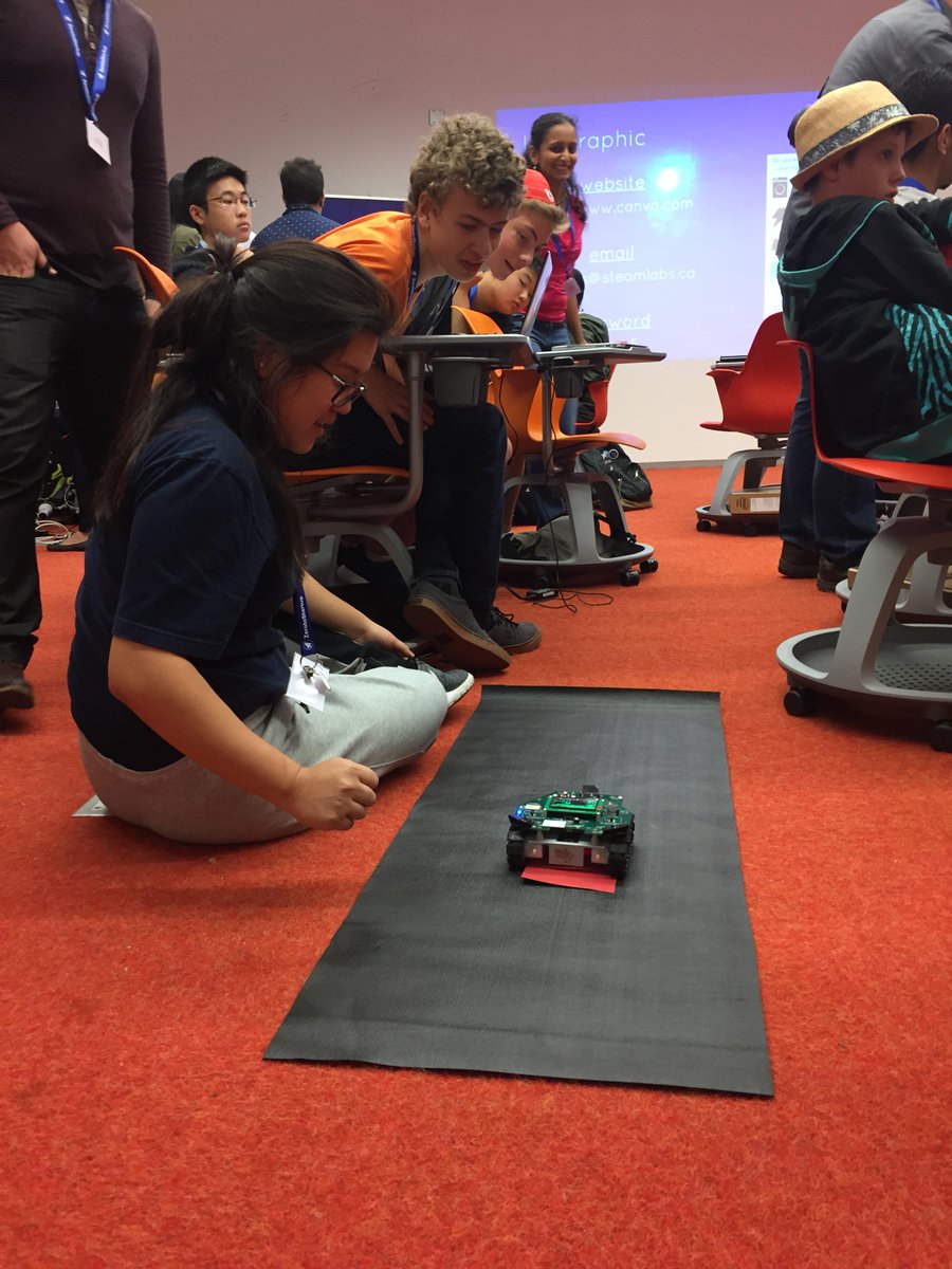 ZerotoStartup's tweet photo. Hard at work- Students design a poster mock up on #sustainablepower knowledge & code a self driving car #Z2S http://t.co/u7xxp6Hbtn