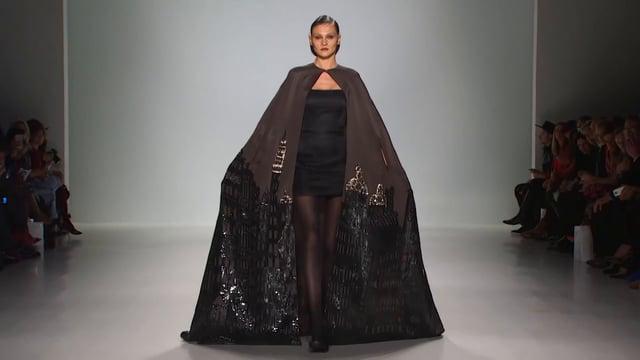 AModernEdge's tweet image. Extravagant cape over little black dress made by Zang Toi