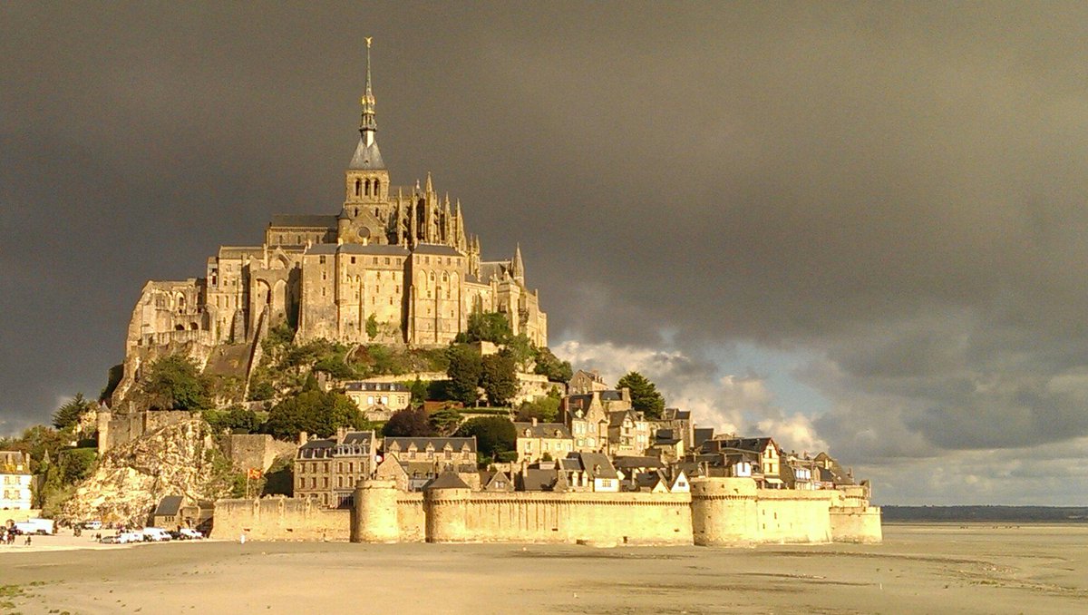 m_nstimp6's tweet photo. Walking towards Mont St Michel. Thankfully the dark clouds soon have way to sunshine. http://t.co/i89TrfkpcG