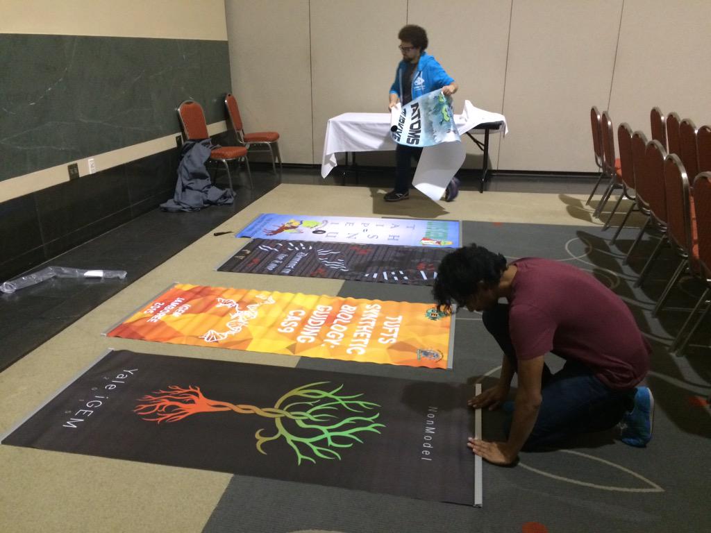 iGEM's tweet photo. Hard at work assembling team banners for #GiantJamboree! http://t.co/Hae9nK6Cuw