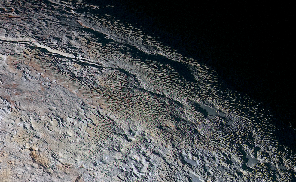 NatGeo's tweet photo. New close-up images of Pluto reveal colorful, scaly terrain: http://t.co/qNVCkhupNE (Image: @NASA) http://t.co/AOcd7P7Eb7