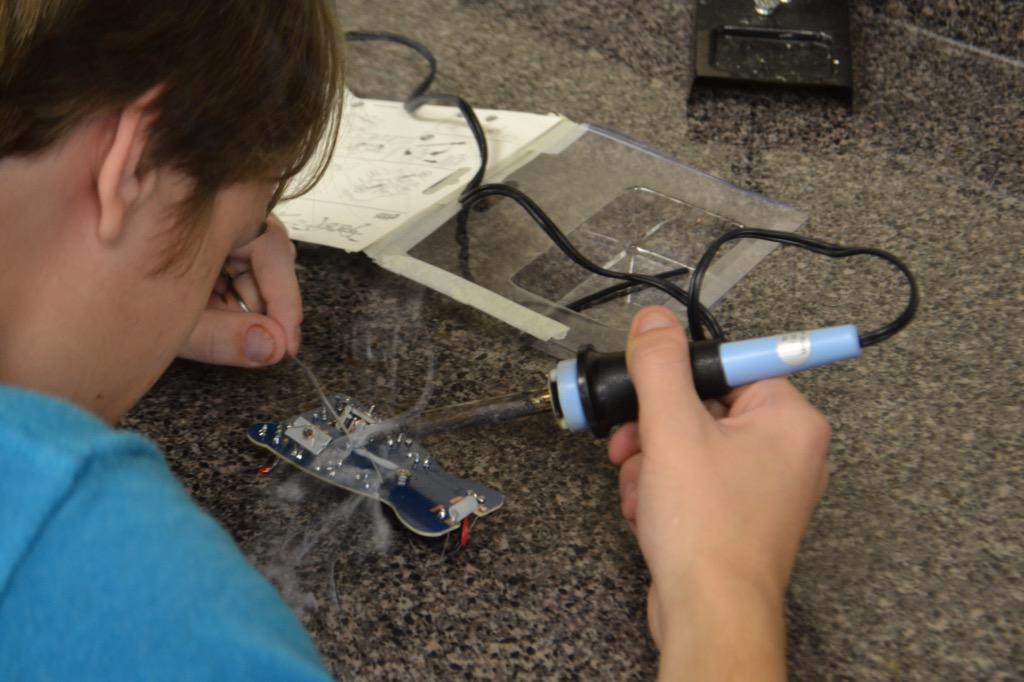 ea_robo_cat's tweet photo. Students soldering, learning the basics of circuitry.  Popularity of class has exploded!@teachleadchange @HeinzEndow http://t.co/3acEbVYFiH