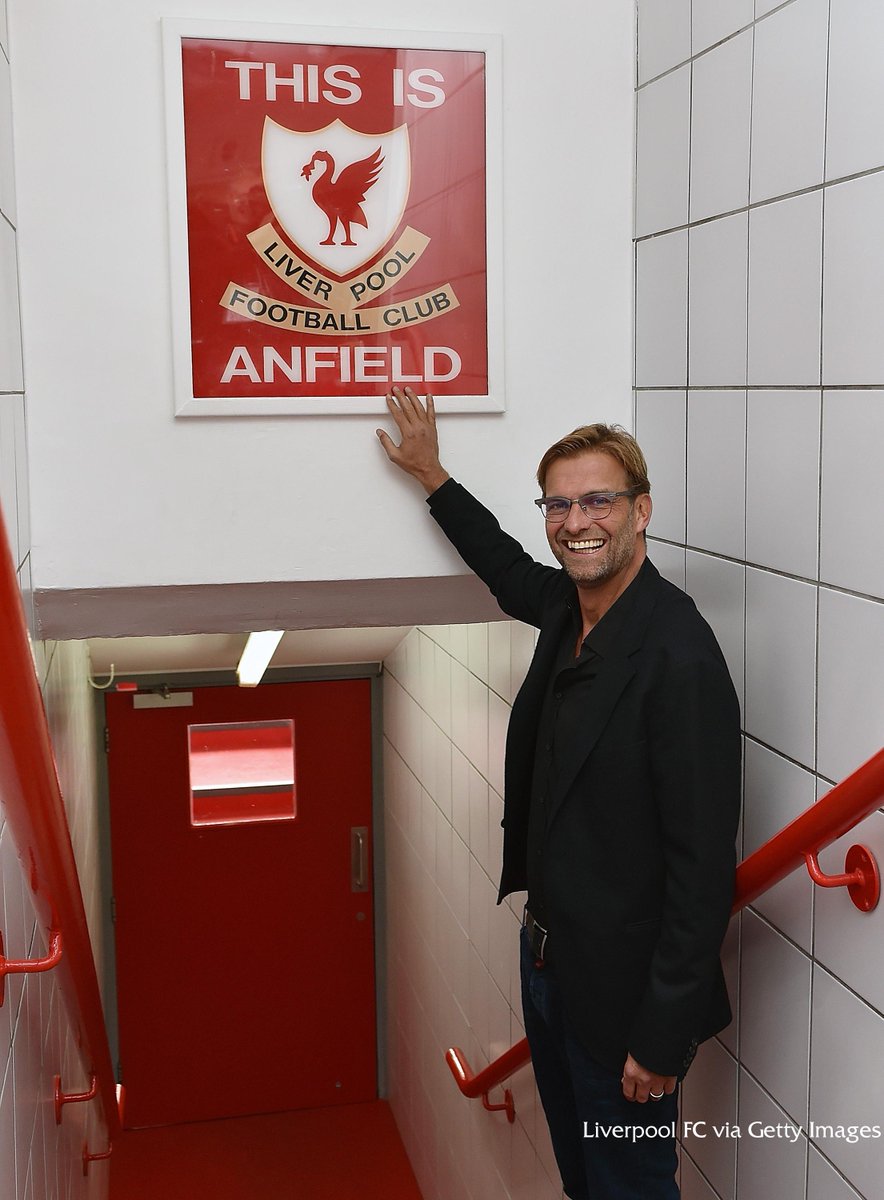 PHOTO: Jürgen Klopp touches the 'This is Anfield' sign for the first time as #LFC manager