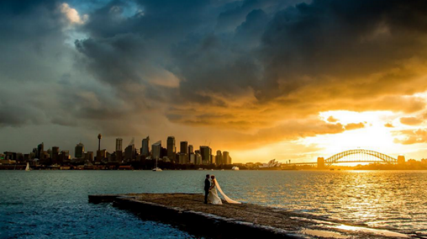 smh's tweet photo. Photographer @samyeldham finds mystery couple in spectacular Sydney Harbour wedding photo. http://t.co/yoMmHRwKJv http://t.co/j8pX86via0