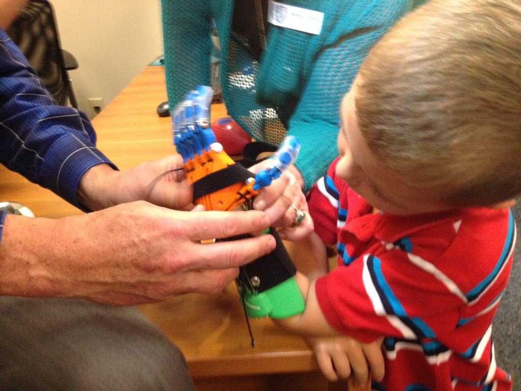 WLBTRoslyn's tweet image. Braden tries out 3D printed prosthetic hand @ Jackson Prep b4 giving 1st Hi 5.