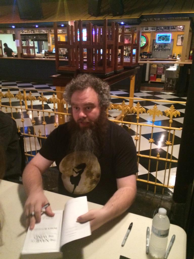 jasonshamblin's tweet photo. Snapped a candid of @PatrickRothfuss while @LindsaySmithDC asked him to sign our books. #MarriageIsTeamwork http://t.co/KwBp27UbJE