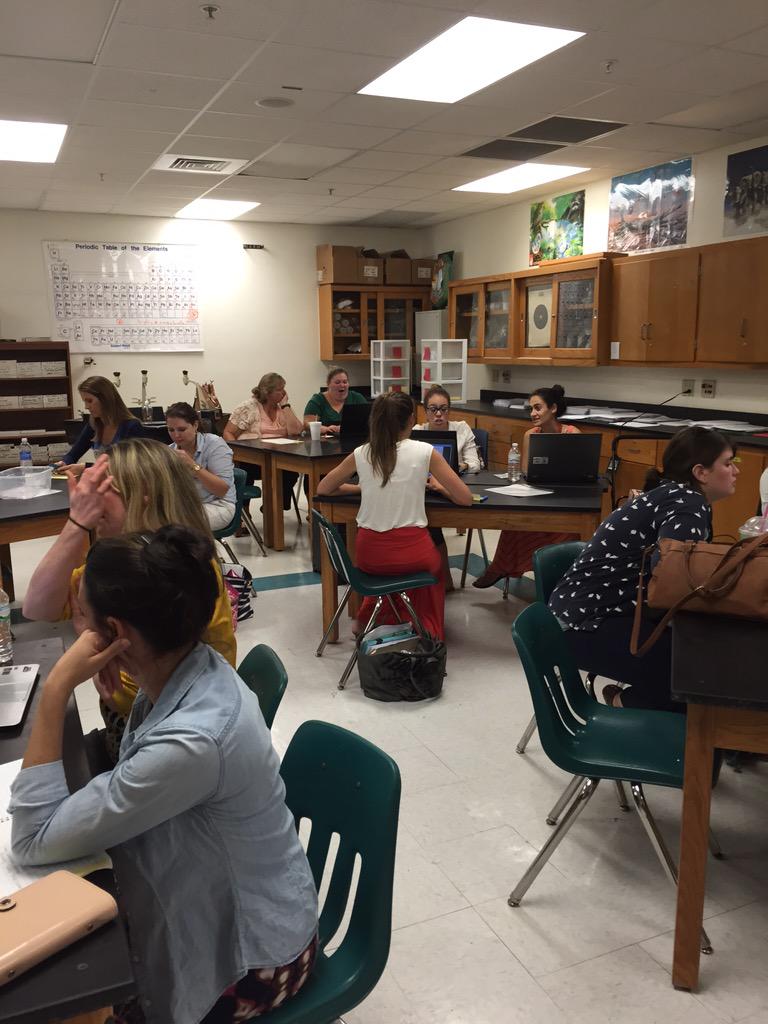 CorrineCob's tweet image. E3 teachers discussing and exploring math resources from the curriculum map. #e3y1