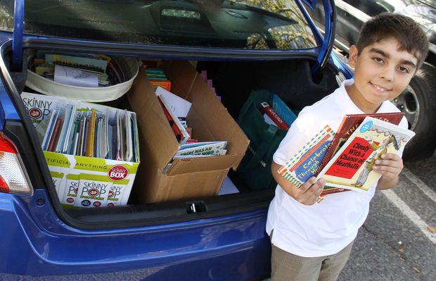 StHelenaStar's tweet photo. St. Helena's Christopher Olivier collects 350 children’s books, donates to fire victims. http://t.co/0UZtkp1a9T http://t.co/CwMLhNKCGN
