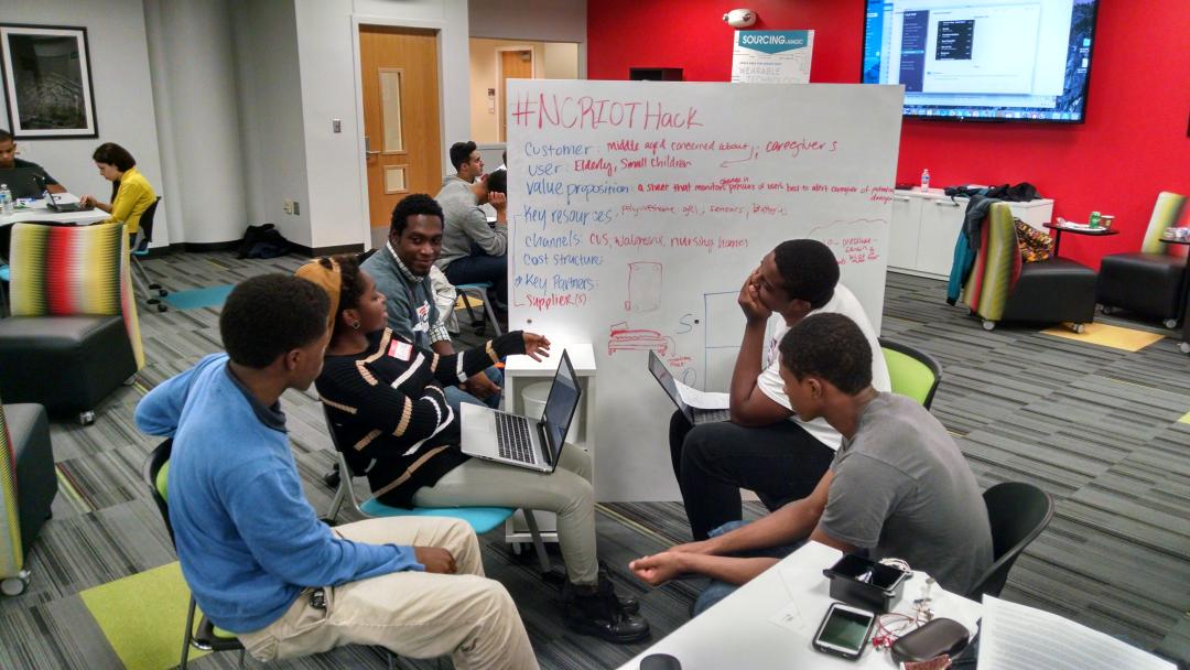 DSInc_Cellio's tweet photo. Another team hacking into the night. #ncriothack begins. @ASSISTCenter @NCRIoT @bright_wolf #hackathoniotnc #cellio http://t.co/CJJGzBvrrB