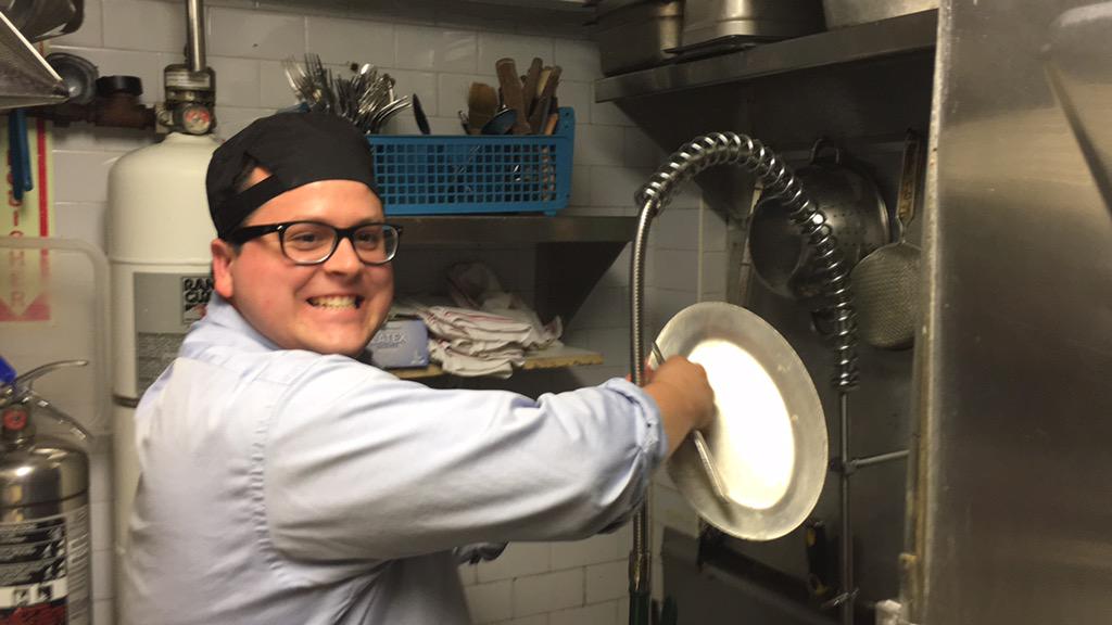 Andy cleaning dishes in the kitchen of the place we just ate at. Challenge completed. 7 down, 20 to go. #survive27