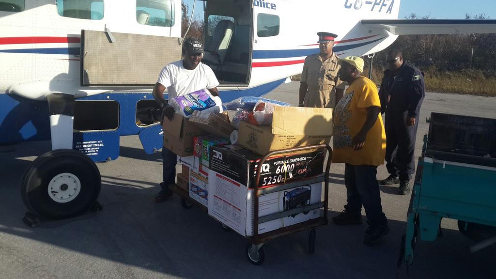 HCGreenslade's tweet photo. Sgt Smith in Rum Cay receiving his supplies, including generator and food from police aircraft at Rum Cay. http://t.co/FBs8vcAKsX