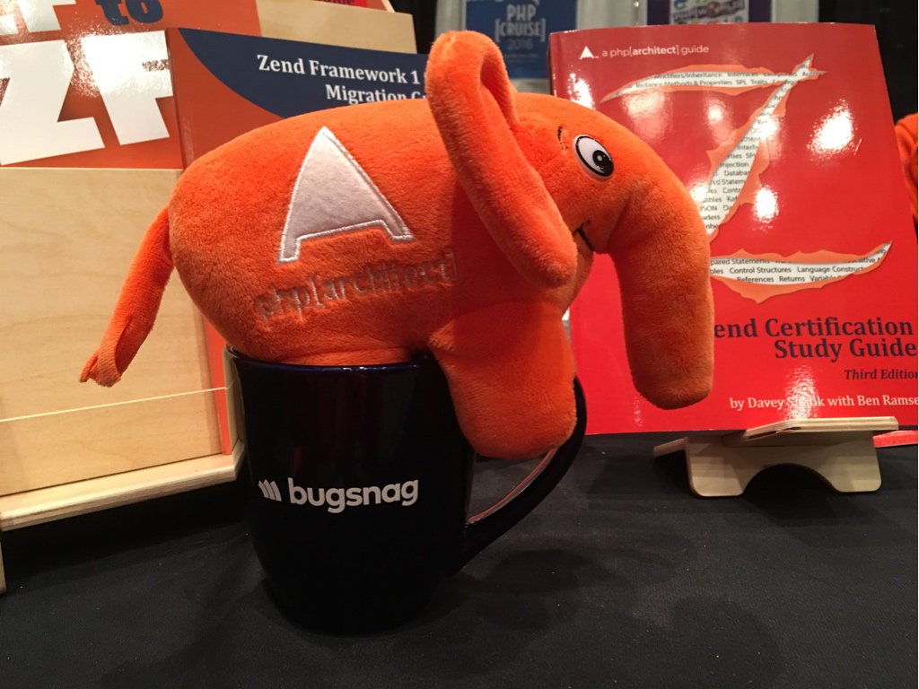 phparch's tweet image. Archie snug as a bug in his @bugsnag mug. #zendcon
