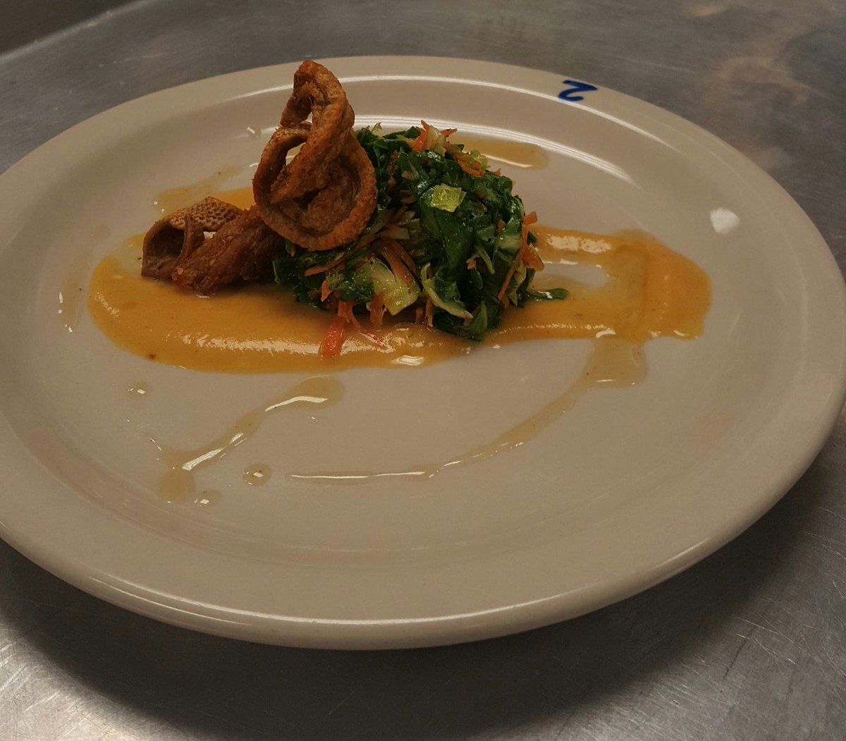 Duck Rinds, Bok Choy and brussels sprout slaw on top of lychees butternut squash puree with a lychees buerre blanc.