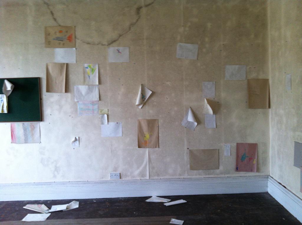 One of the creepiest rooms in the asylum..children's drawings still stuck on the wall with their names on.!