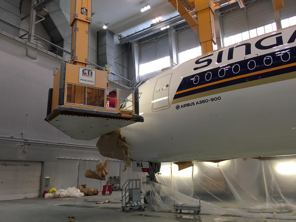 Exec_Traveller's tweet photo. Peeling the paper off Singapore Airlines' first Airbus A350 #avgeek http://t.co/g5ARmEQi82