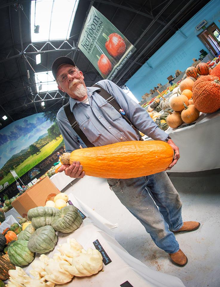 Farmer holding a giant orange squash