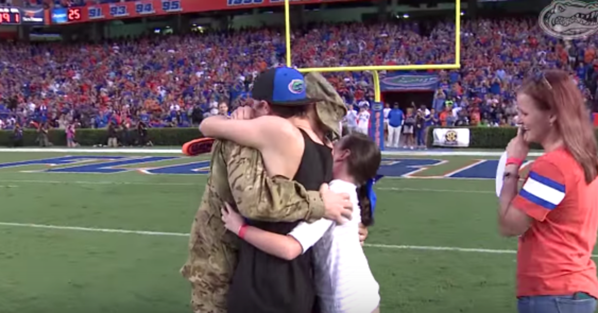 HuffPost's tweet photo. Military dad surprises family in heartwarming football field reunion http://t.co/Wmou5sYKiX http://t.co/PjTdlwwKG5
