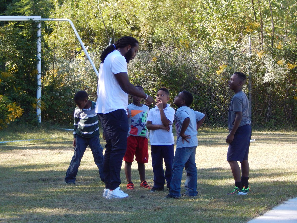 BGCGC's tweet photo. BGCGC members huddle up with @Bengals DE @W_Clarke98 to learn game winning plays for the #bgcbowl against Cleveland! http://t.co/yp4yqbClsT