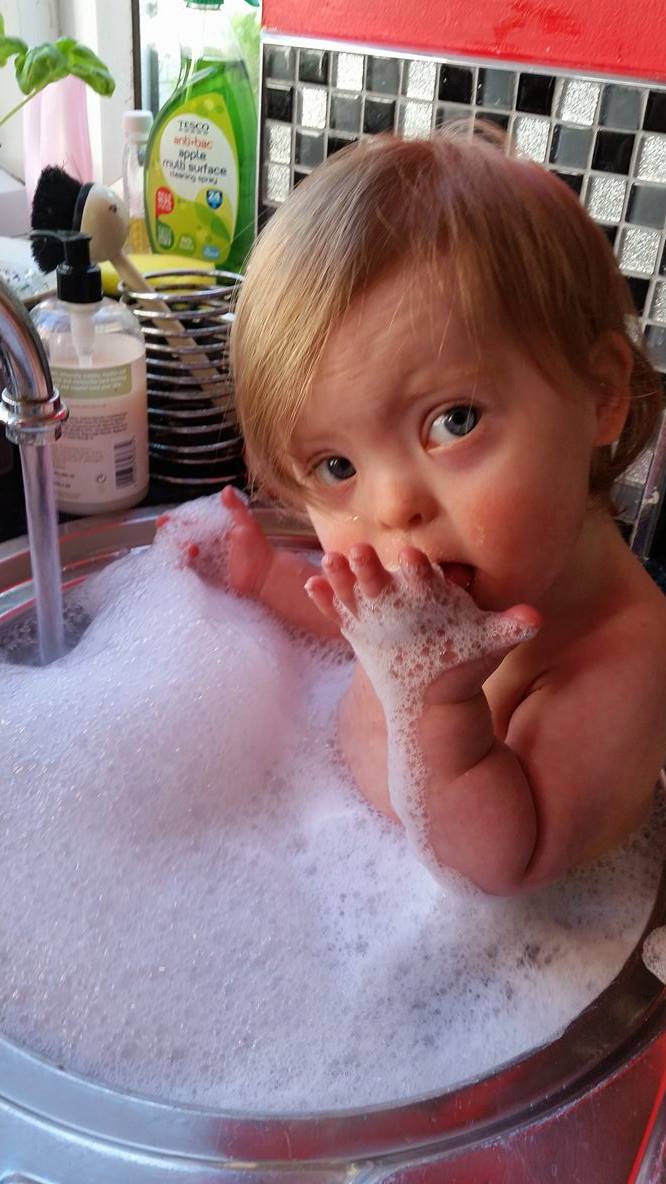 alanalorente's tweet photo. I love that even though Eva is 17 months old, she still fits in the sink! #downsyndromerocks #tinykid https://t.co/9PgFKzc64g