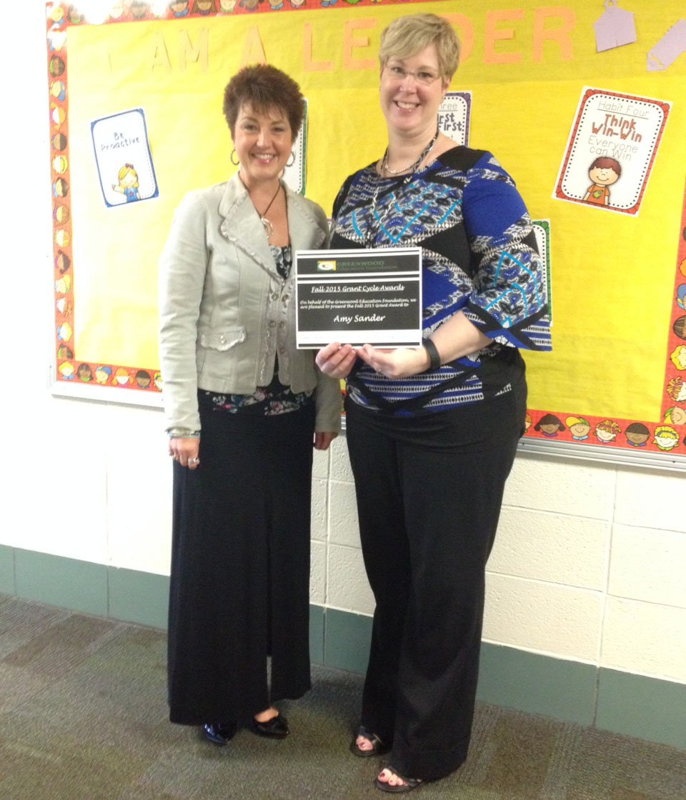 Mrs. Sander,NE principal is surprised by <a href="/gef_gw/">GW Edu. Foundation</a> Donna Jones with a grant to support a 5 day STEM camp for students.