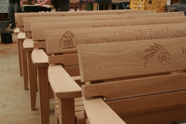 Hand carved memorial Chico benches ready to go in the <a href="/MadebyBenchmark/">Benchmark</a> workshops
