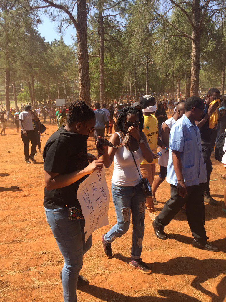 MapsMaponyane's tweet photo. Teargas has all the protesters, choking and dispersing in all sorts of directions to get as far away. #FeesMustFall https://t.co/NomtbNqHEd