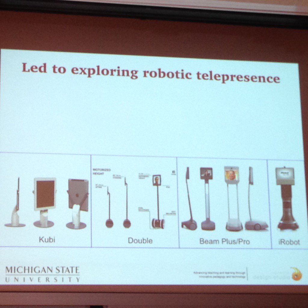 _valeriei's tweet photo. John Bell reviewing different robots. Also the @Vgocom which is on site as well being used in the #cohere15 keynote https://t.co/JHnmSiLfzA