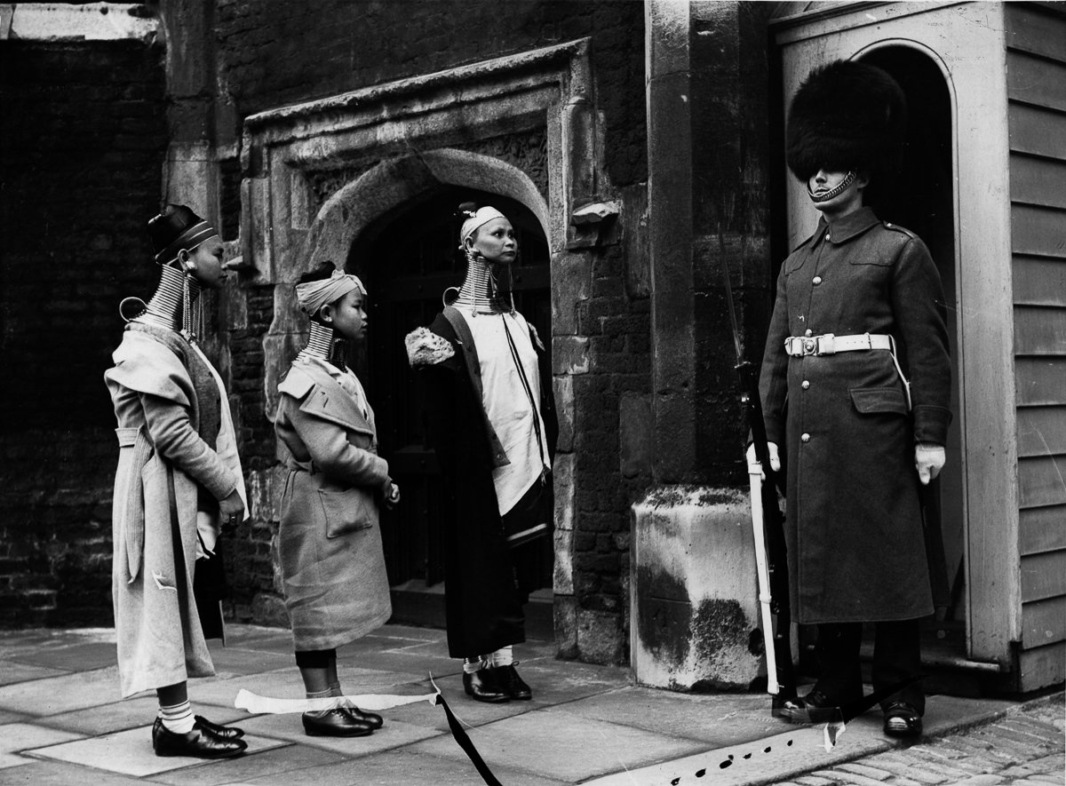 Burmese Kayan women in London looking at a Grenadier guard, 1935 ...