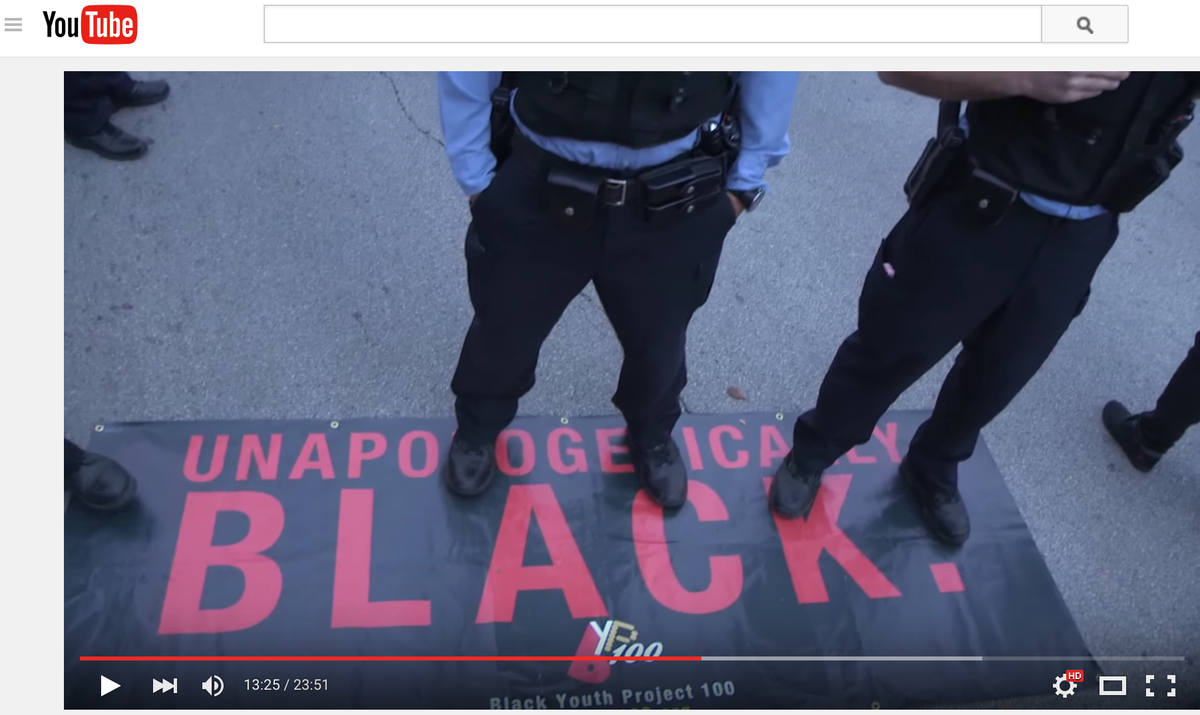 byp100's tweet photo. Cops stood on our "Unapologetically Black" banner as a passive-aggressive display of intimidation. #StopTheCops https://t.co/h1jiGbsNkq