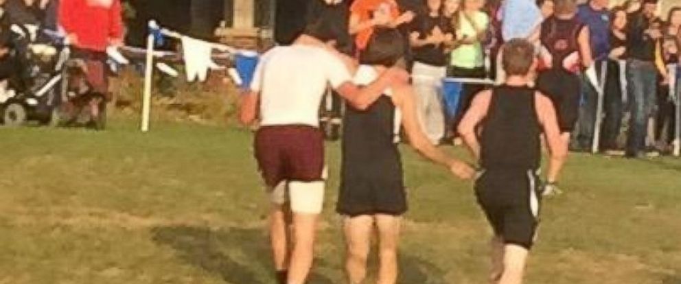 ABC's tweet image. Runner disqualified after helping collapsed rival finish race...but is hero of rival school: abcn.ws/1Xxz1c3