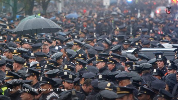 nytimes's tweet photo. At the funeral for the NYPD officer shot last week, thousands mourned "a remarkable man" https://t.co/0CoZdIfaUm https://t.co/ZVVmQg9PLS