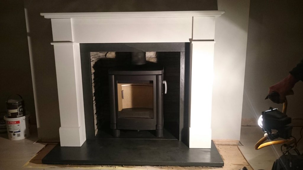 Contura 51l writhe the Marco in honed Blanco marble and stacked stone chamber. Brazilian slate hearth. Stunning!!
