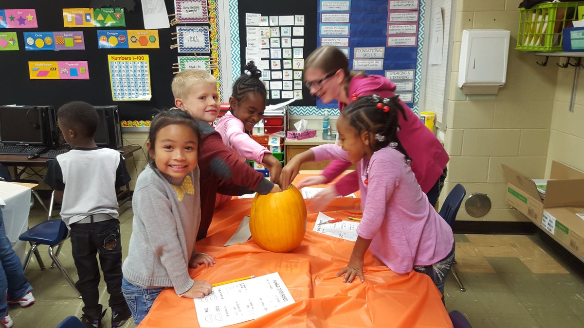 First grade students engaging in pumpkin investigation to learn math and science!  Thanks Mrs. Myers and volunteers!