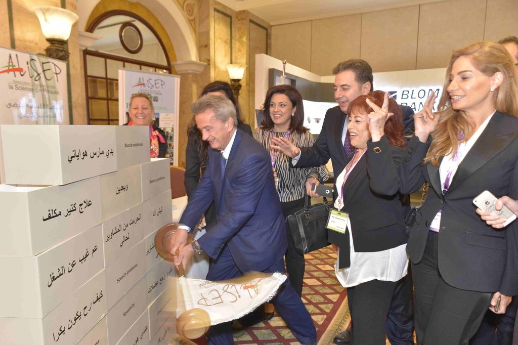 csrlebanon's tweet photo. #CSRLB5 : Salameh brings down a wall comprised of blocks each representing a differemt effect of #MultipleSclerosis https://t.co/NJJWNbvK0C