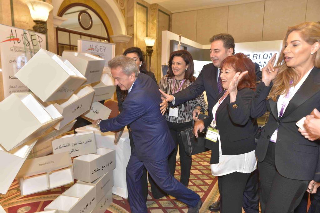 csrlebanon's tweet photo. #CSRLB5 : Salameh brings down a wall comprised of blocks each representing a differemt effect of #MultipleSclerosis https://t.co/NJJWNbvK0C