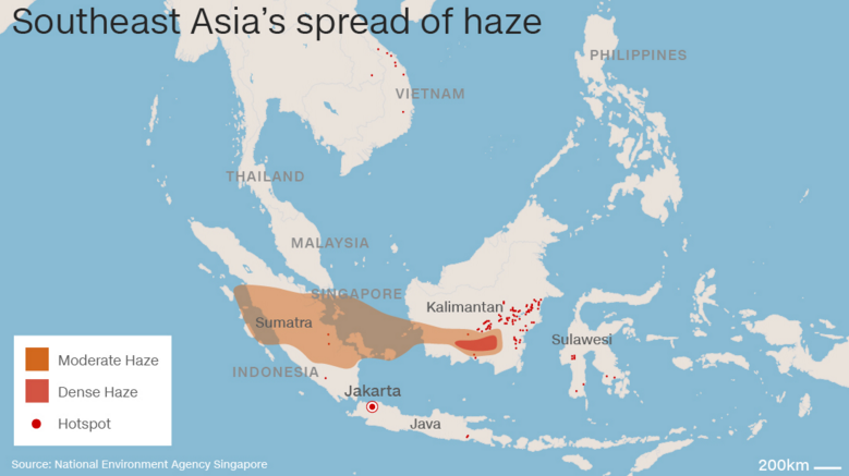 What is the human and environmental impact of the acrid haze blanketing Indonesia?