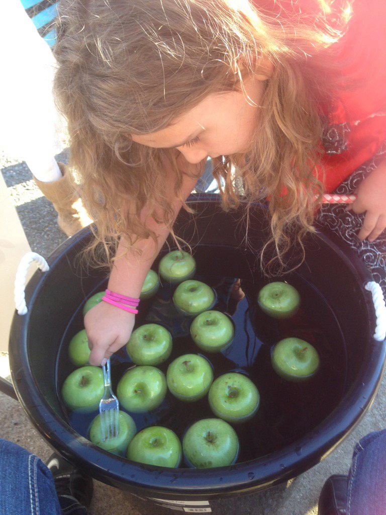 Bobbing for apples with a plastic fork at Fall Featival.