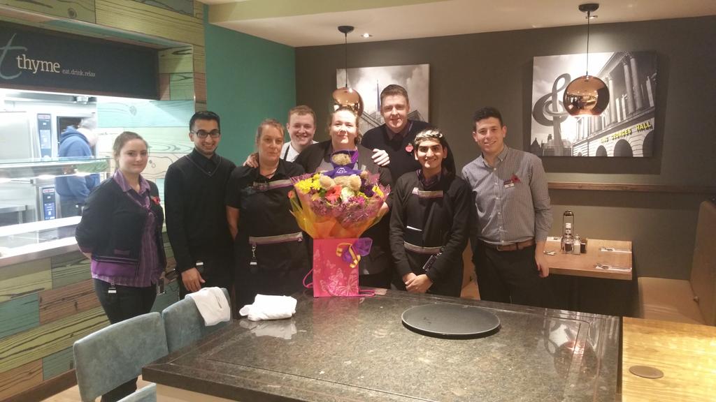 Blackburn Town Centre PI presenting their new openings trainer with flowers. Thanks for all the hard work.
