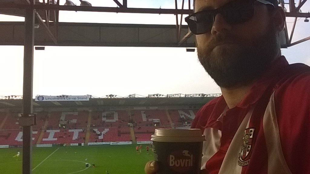 SimGibson's tweet photo. Getting ready for @LincolnCity_FC vs Bromley. Odd not to have @myf to remark on my choice of beverage... https://t.co/z9Ixlm0A7S