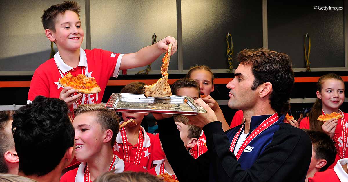 atptour's tweet photo. One slice or two? @rogerfederer serves up pizza to #Basel ballkids after Sunday's final. https://t.co/zsFXymss0H https://t.co/TI3GuwS3FE