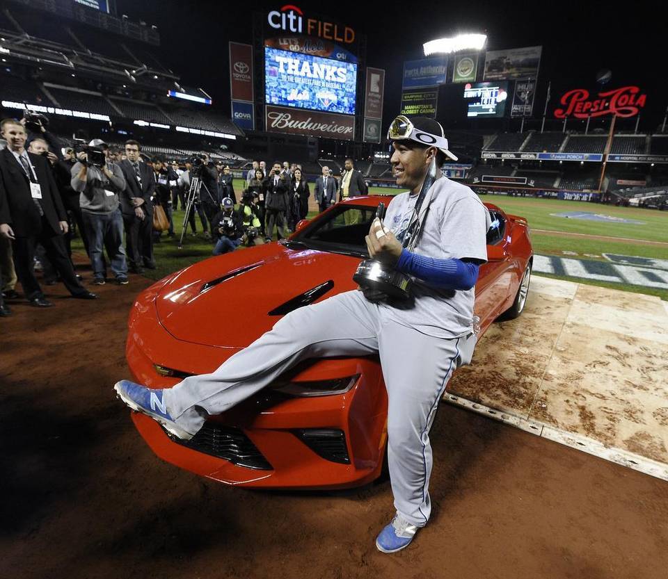 KCStar's tweet photo. #Royals catcher Salvador Perez posed with the MVP trophy and the car he was awarded https://t.co/58dJLcTa75