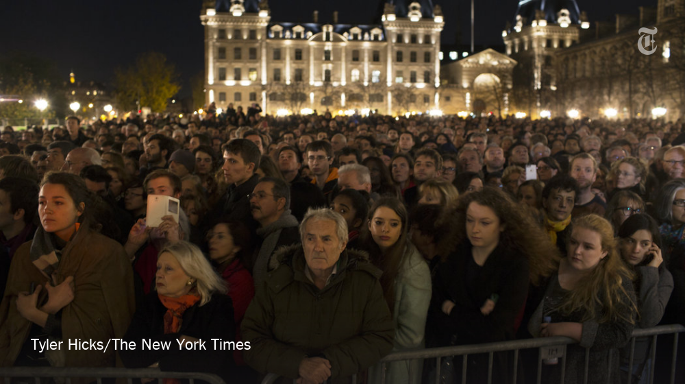 nytimes's tweet photo. People gathered outside the Cathedral of Notre-Dame in Paris for a memorial service https://t.co/LkxRtul2OM https://t.co/y0bIpIcfjE
