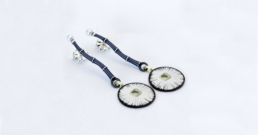 A pair of oxidized sterling  with 18k YG bamboo earrings by Susan Mahlstedt. Come view her line in our gallery.