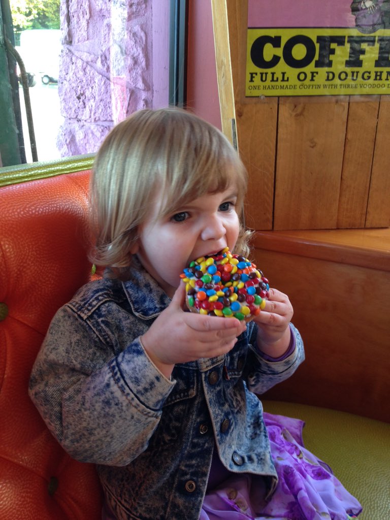 Peri digging into her first of many <a href="/VoodooDoughnut/">Voodoo Doughnut</a>