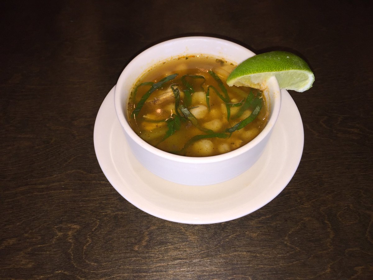 Pozole! Made with chicken, hominy, green chili, red onion &amp; cilantro, topped with basil &amp; served with a lime wedge.